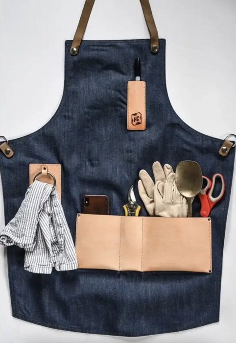 The apron is shown with all its pockets filled with gardening tools