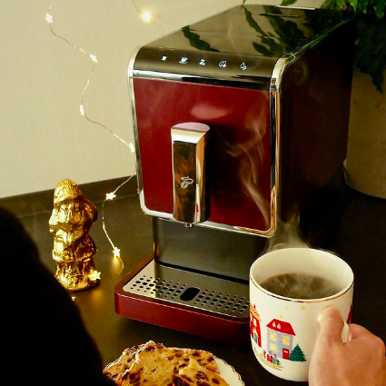A sleek coffee machine placed on the counter, ready to brew your favorite cup of coffee.