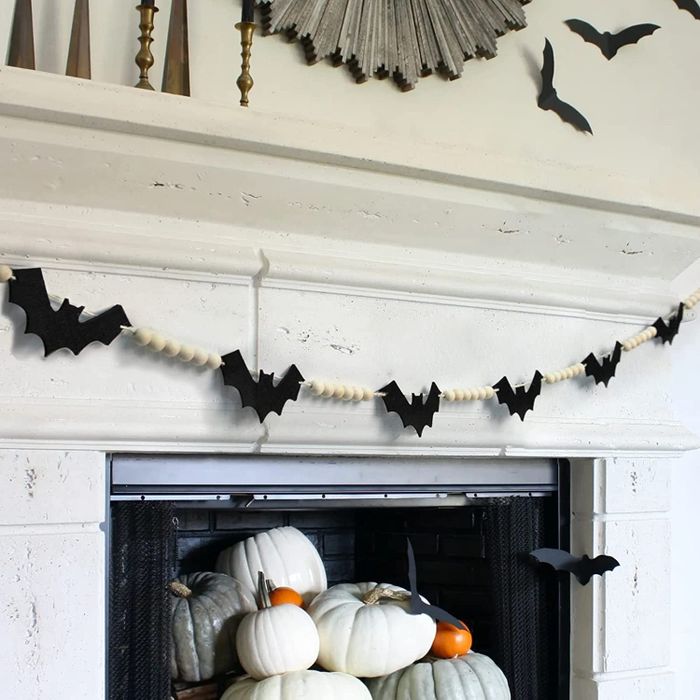 bat-shaped beaded garland hanging above a fireplace