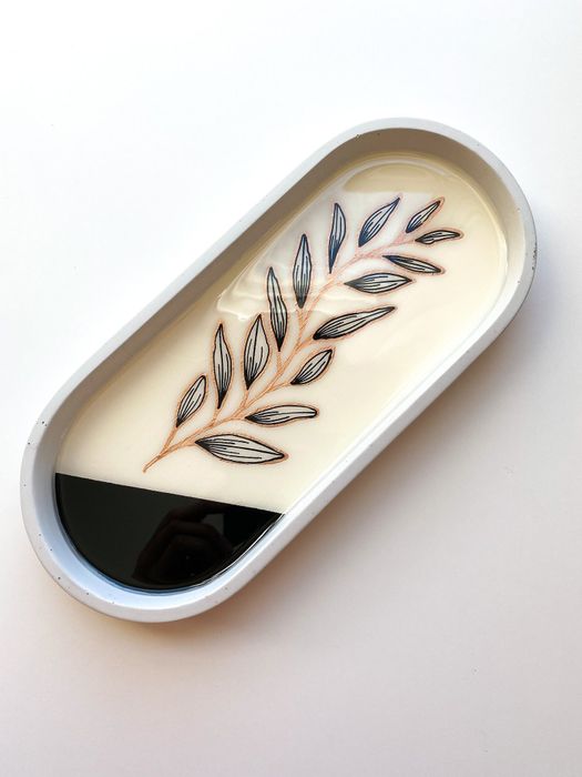 A concrete tray featuring an intricate floral design.