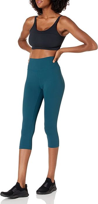 model wearing the aquamarine blue leggings paired with a sports bra
