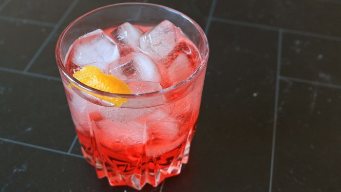 A refreshing red low-alcohol beverage served over ice.