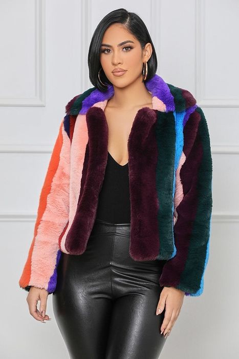 a model styling the Samba faux fur jacket over a sleek black outfit