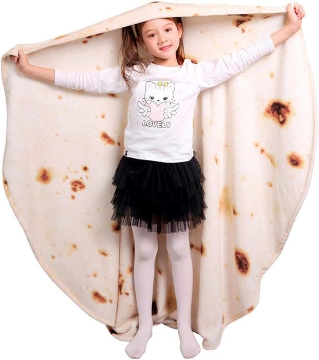 A child holding their tortilla blanket, ready to be wrapped up like a burrito.