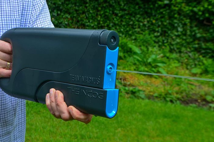 A model spraying a black water blaster with blue accents.