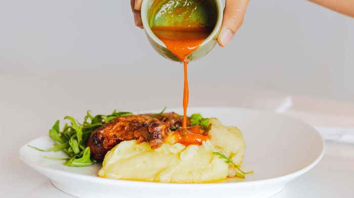 A drizzle of hot sauce brings a bold kick to mashed potatoes.