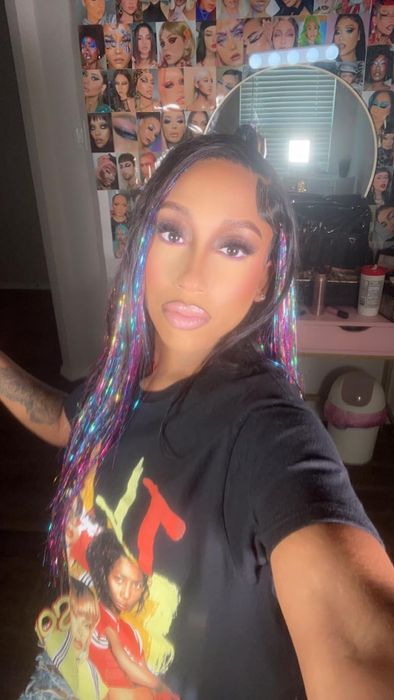 A reviewer with vibrant tinsel extensions in their hair.