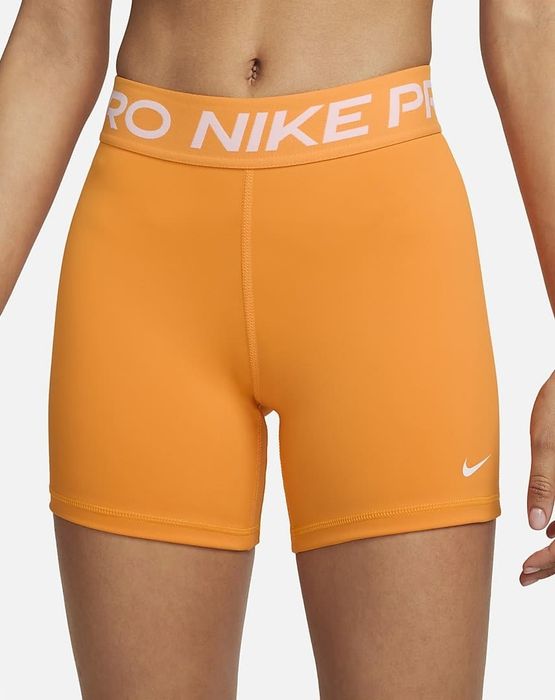 Image of model wearing orange shorts