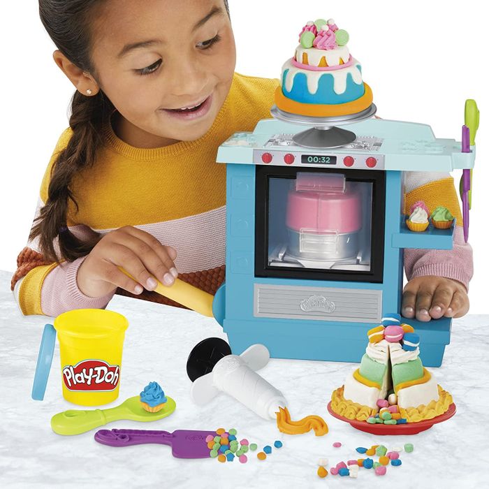 A child model having fun with the Play-Doh bakery set.