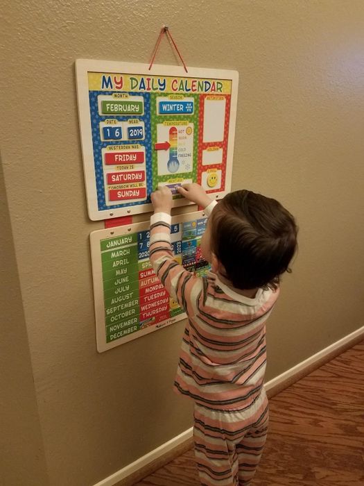 The reviewer's child engaging with the magnetic calendar.