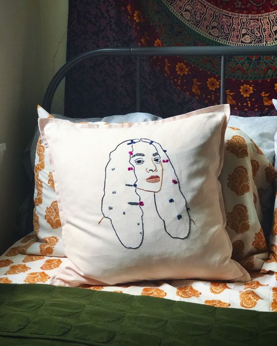 the Solange 20x20 pillow displayed on a bed