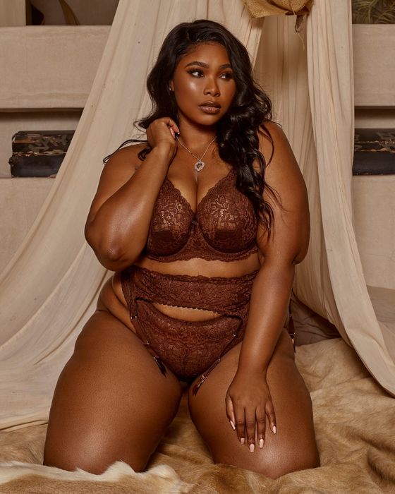 Model showcasing the brown bra, garter, and panties