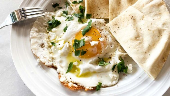 Fry your eggs over a heap of crumbled feta for a creamy, indulgent twist.