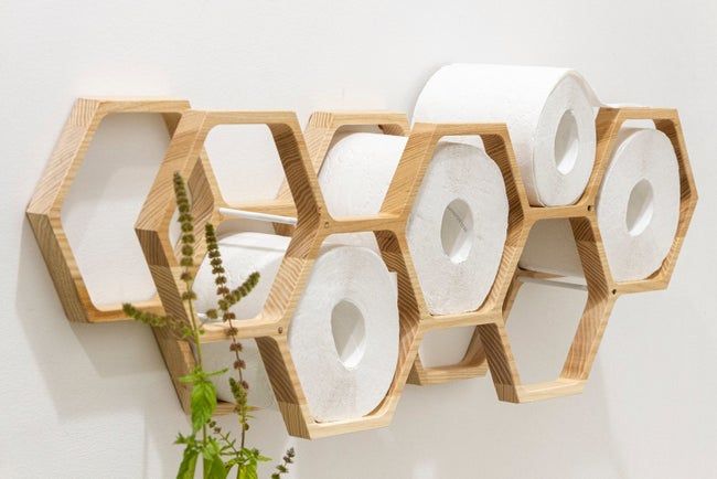A honeycomb-shaped organizer filled with toilet paper rolls.