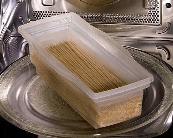 The pasta cooker filled with pasta and water, ready to be microwaved