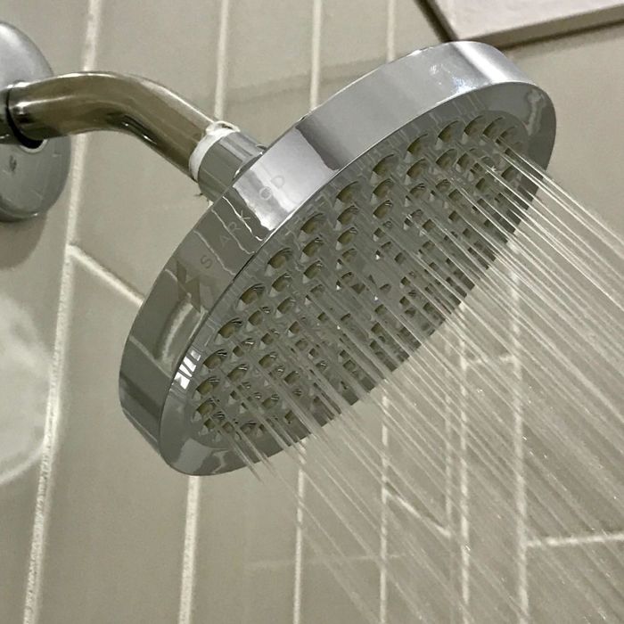 a reviewer photo showing the large silver showerhead