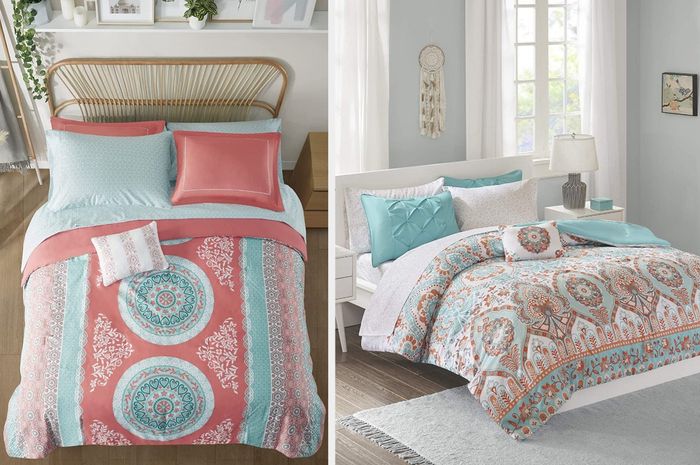 A coral and teal medallion comforter paired with coral pillowcases and a striped coral and white throw pillow, set on a wooden bed frame, with matching pillows in teal, white, and orange to complete the look.
