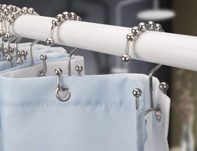 Double-sided hooks with a shower curtain on one side and a liner on the other.