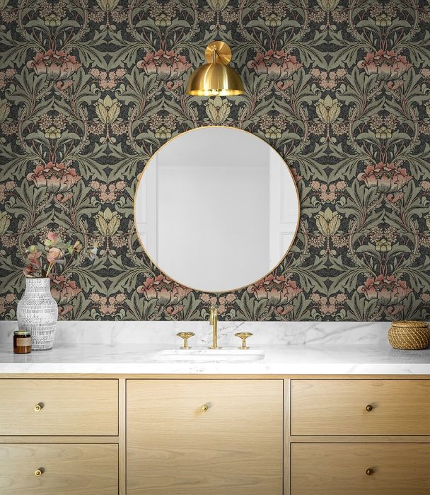 the wallpaper placed behind a mirror above a bathroom sink