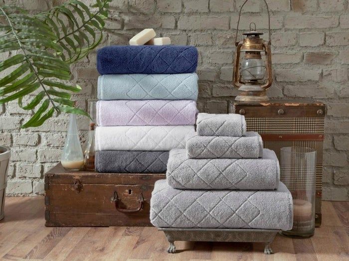 the towel set available in shades of gray, navy blue, charcoal gray, lavender, and light blue