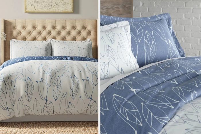 Reversible duvet cover with white and blue leaf print, accompanied by matching pillowcases, displayed on white sheets against a white brick wall.