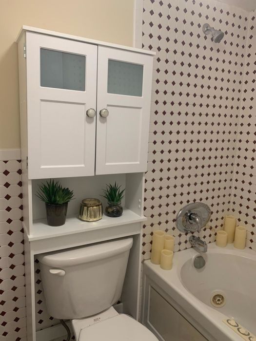 A reviewer's white cabinet with updated handles that were refurbished for a fresh look.