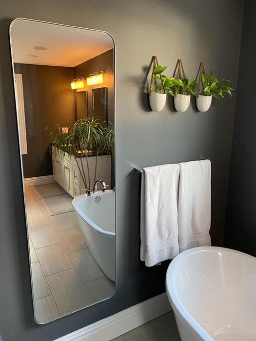 A photo of the mirror placed in a bathroom.