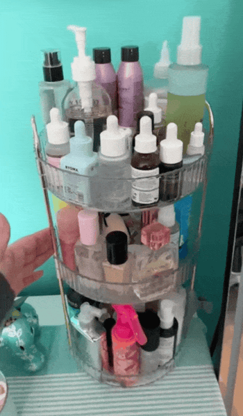 A rotating shelf stocked with different skincare and beauty products, including serums, creams, and sprays, offering organized storage and convenient access