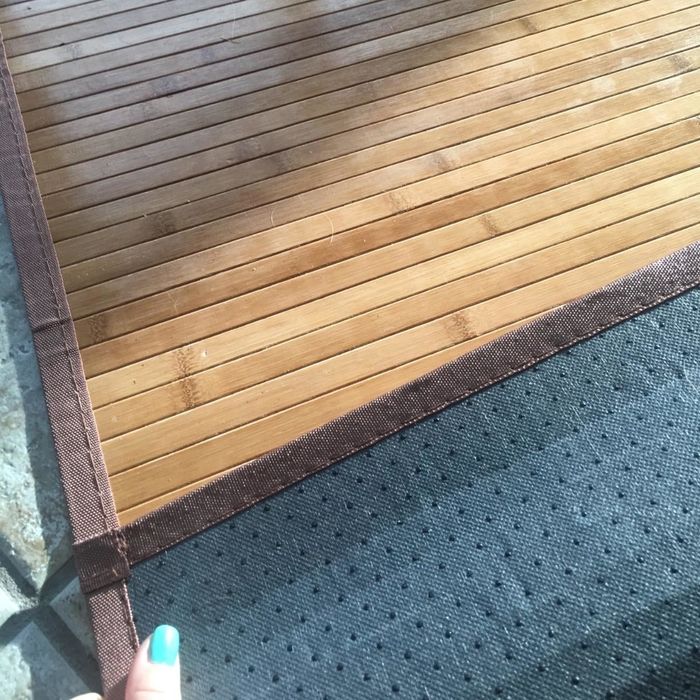 A reviewer image featuring the bamboo bath mat.