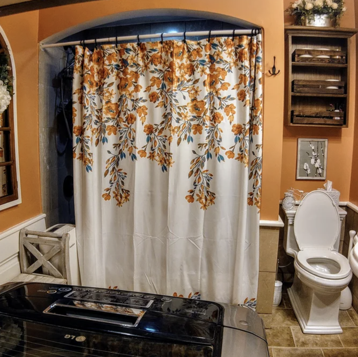 Image of a shower curtain adorned with vibrant orange flowers