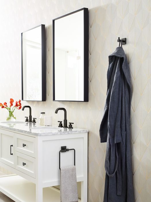 the square wall-mounted hook with a towel draped over it