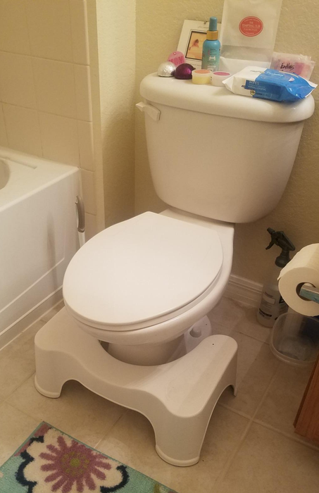 A reviewer photo featuring the Squatty Potty placed in front of a toilet.