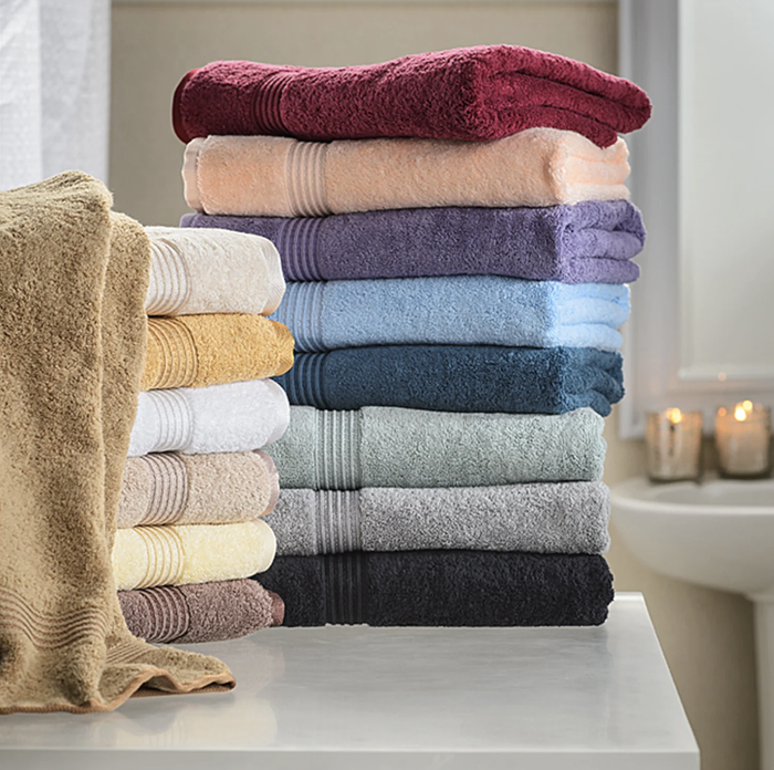 A colorful stack of towels displayed on a counter