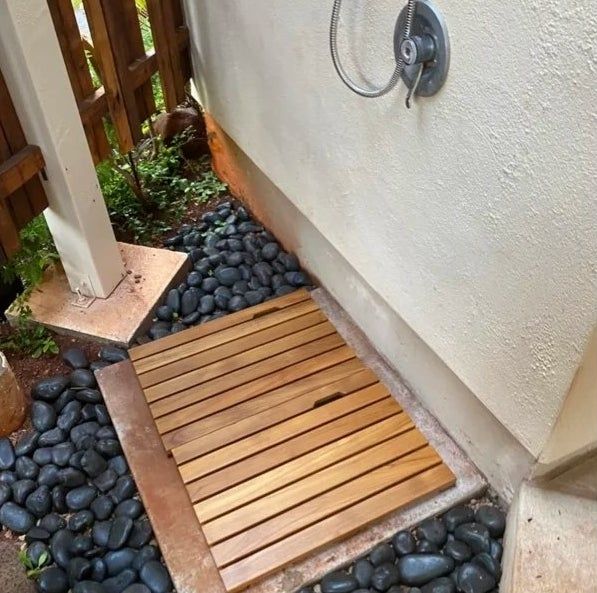Two teakwood bathroom mats positioned side by side.