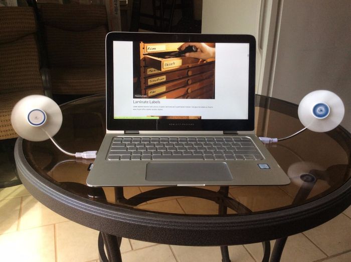 Reviewer's two USB fans attached to a monitor and laptop