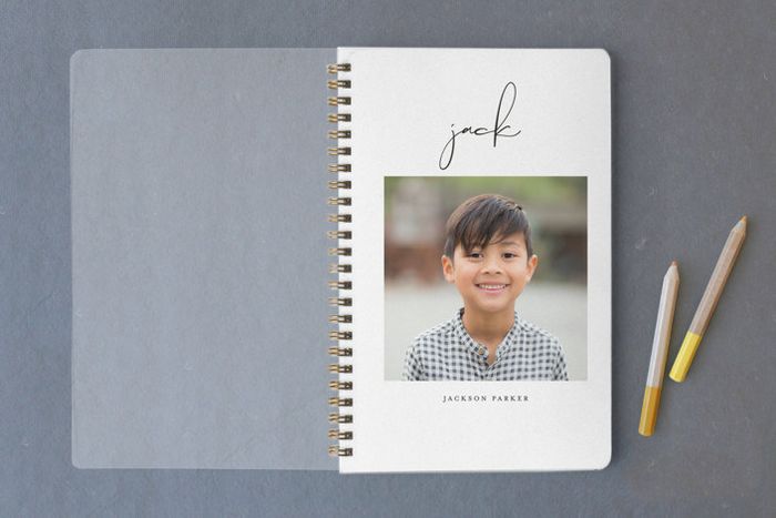 the notebook featuring a child’s face on the cover