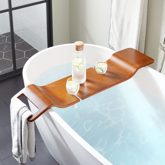 the wooden caddy positioned over a bathtub