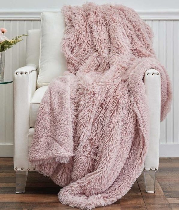 the blanket elegantly draped over a chair
