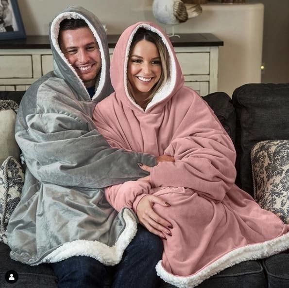Two people cozily wrapped in the blankets