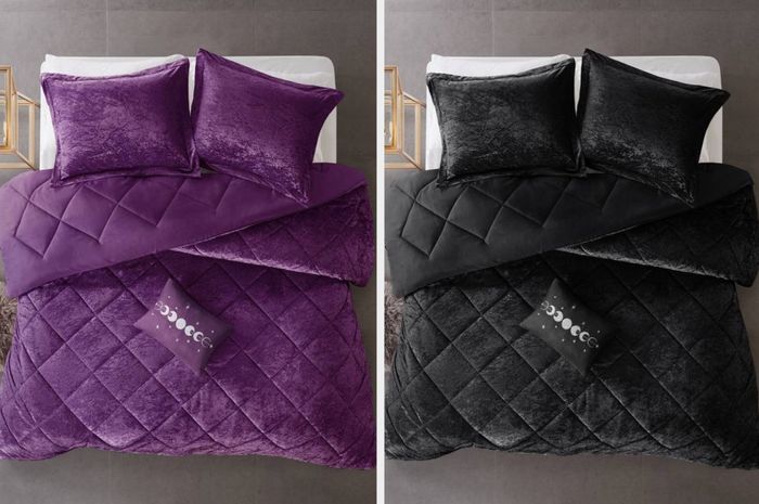 A dark purple velvet tufted comforter with matching pillows and a moon-shaped throw pillow, placed next to a nightstand, complemented by a black product and a white fitted sheet.