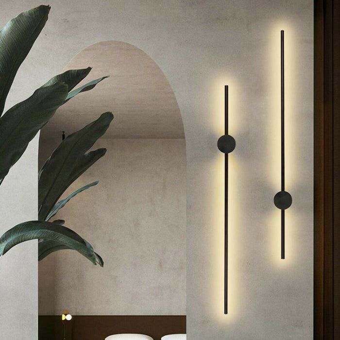 the minimalist wall sconces resembling glowing black lines