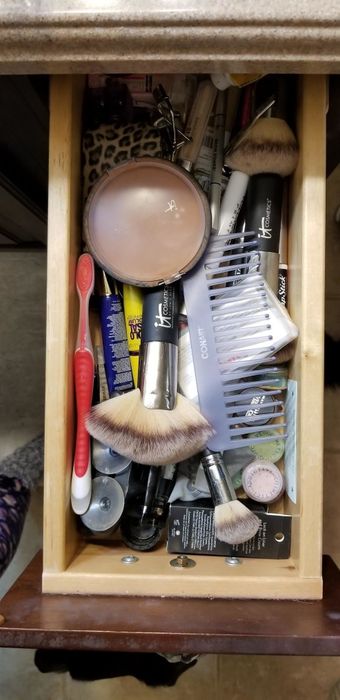 A photo showing a cluttered drawer or an unorganized space