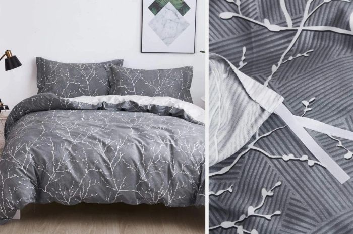 A gray and white duvet cover adorned with a delicate branch pattern, complete with matching pillows against a white wall, showcasing a close-up of the material with white interior ties.