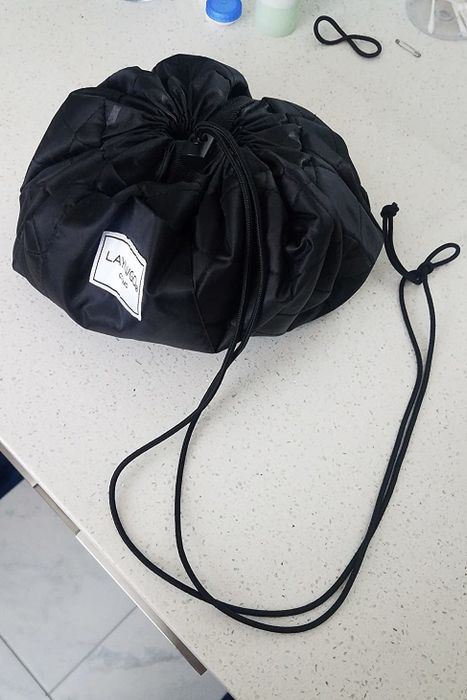 A reviewer's photo showing the makeup organizer tightly cinched.