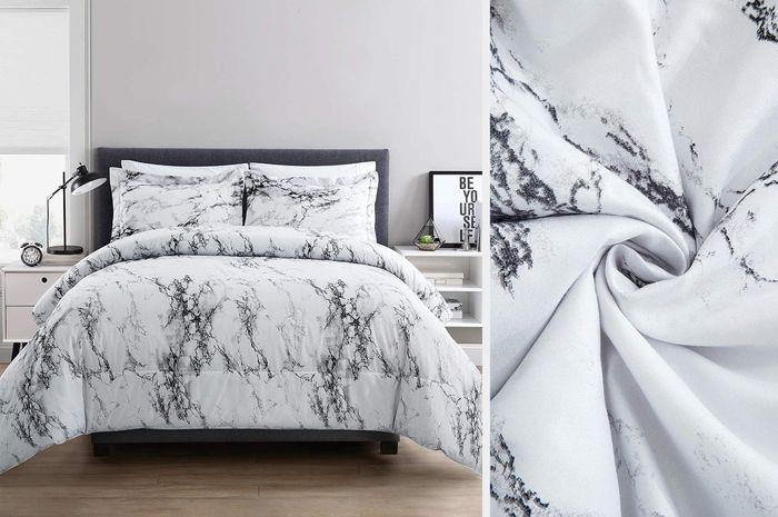 A black and white marble printed comforter with matching pillows, placed on a hardwood floor next to a white nightstand, with a close-up shot of the twisted comforter material.