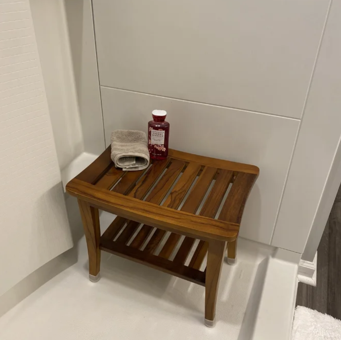 A review image showing the bench placed inside a shower.