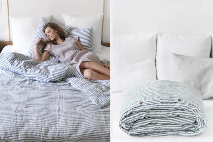 A model lounging on a blue and white striped linen duvet cover with matching pillows, placed on white sheets against a white wall. The product is folded on white sheets with white pillows.
