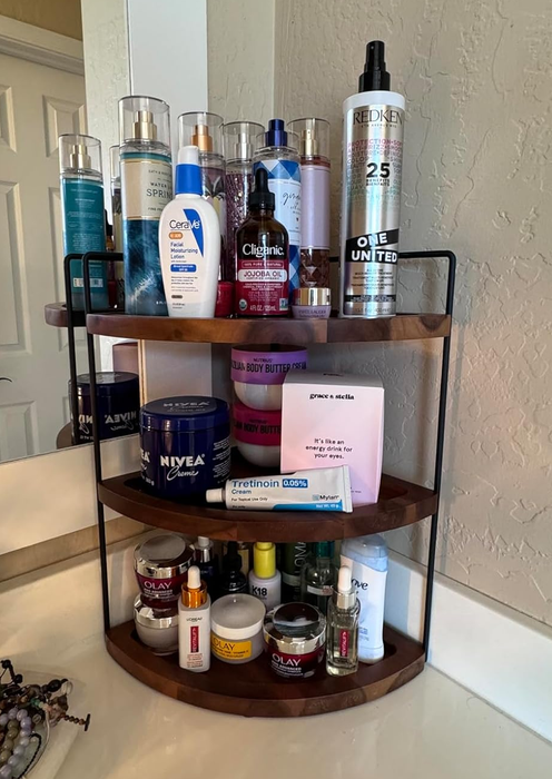 A three-tier bathroom shelf showcasing an array of skincare and haircare products