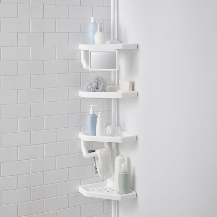 the white shower caddy positioned in the corner of a shower