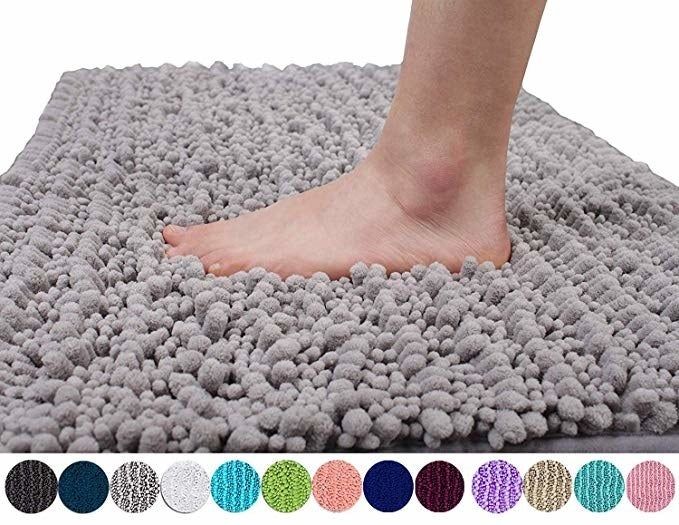 Product image showing a foot stepping onto a gray bath mat